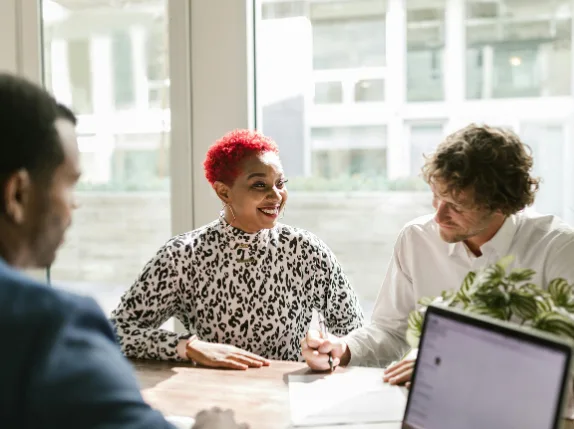 An insurance adviser talking a customer through her options across a desk